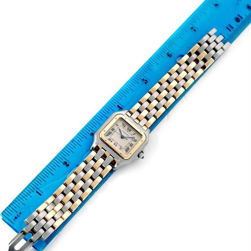The Cartier Panthère watch is shown flat with its face and full bracelet displayed, alongside a ruler for scale.