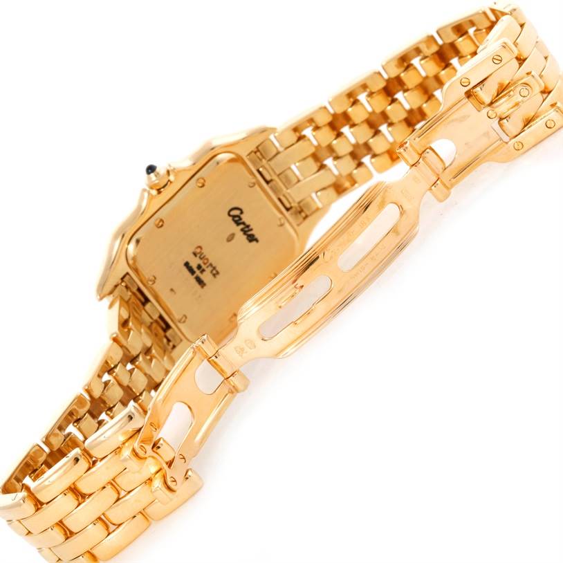 The image shows the back view and clasp of a Cartier Panthere Yellow Gold Silver Dial Yellow Gold Silver Dial watch, highlighting its gold bracelet and case back.