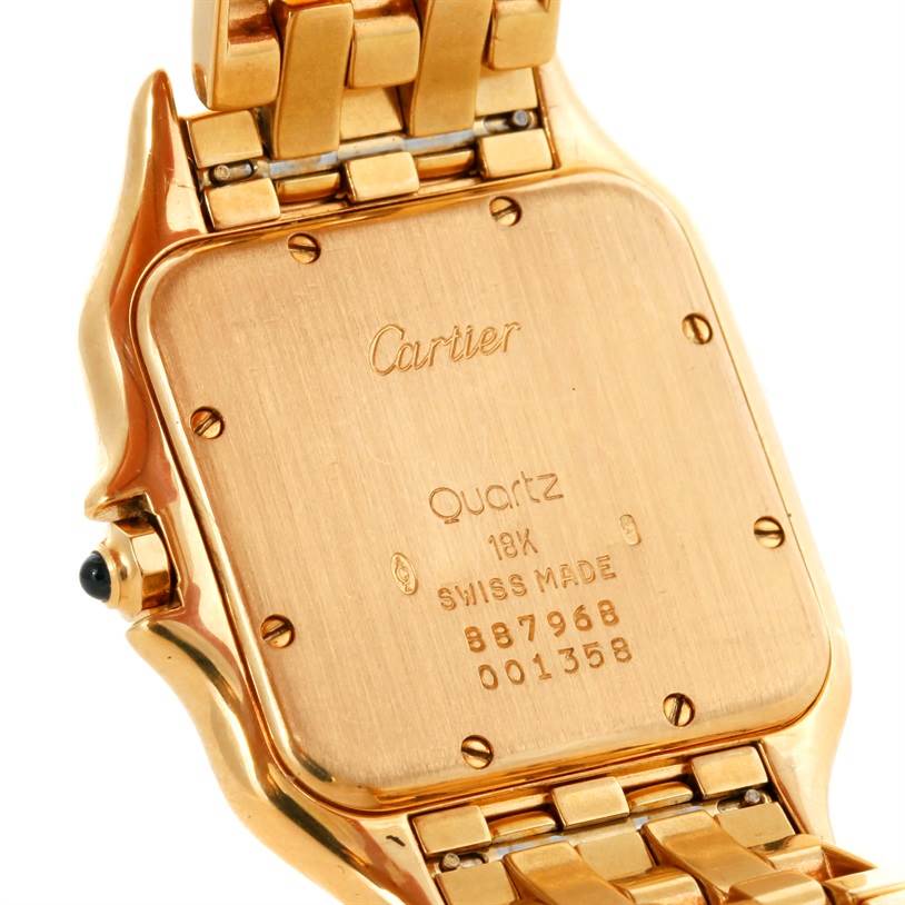 The image shows the back case and part of the bracelet of a Panthere model Cartier watch.