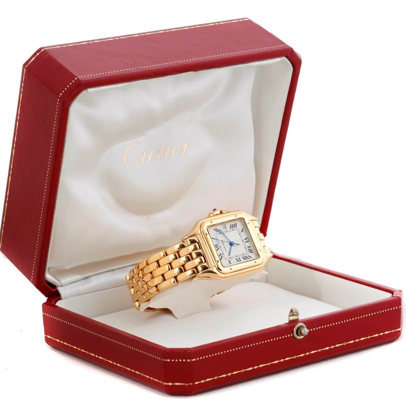 The Cartier Panthere W25014B9 Men's Yellow Gold Silver Dial W25014B9 Men's Yellow Gold Silver Dial watch is shown at an angle inside an open red box, highlighting the face and band.
