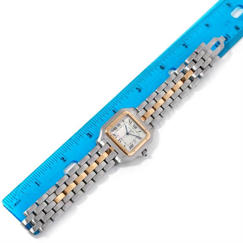 The image shows the face and full bracelet of a Cartier Panthere Steel and Gold (two tone) Silver Dial Steel and Gold (two tone) Silver Dial watch placed next to a ruler for scale.