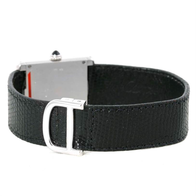 The Cartier Tank Classic Men's White Gold Beige Dial Men's White Gold Beige Dial watch is shown from the back angle, highlighting its black leather strap and clasp.