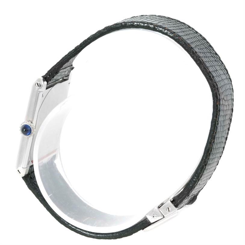 The image shows a side view of the Cartier Tank Classic Men's White Gold Beige Dial Men's White Gold Beige Dial watch, highlighting its crown and black leather strap.