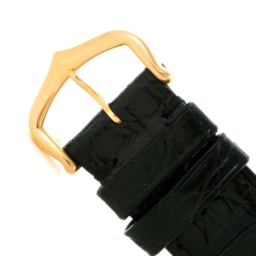 The image shows a close-up of the buckle and strap of the Cartier Tank Classic Men's Yellow Gold Silver Dial Men's Yellow Gold Silver Dial model.