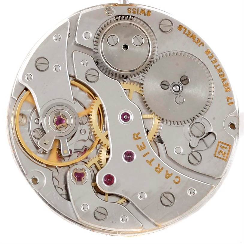 This image shows the inner mechanical movement of the Tank Classic model by Cartier, displaying gears and the intricate workings.