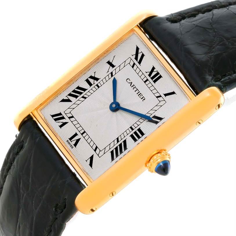 The image shows a Cartier Tank Classic Men's Yellow Gold Silver Dial Men's Yellow Gold Silver Dial watch angled slightly downward, highlighting the face, Roman numerals, and black leather strap.