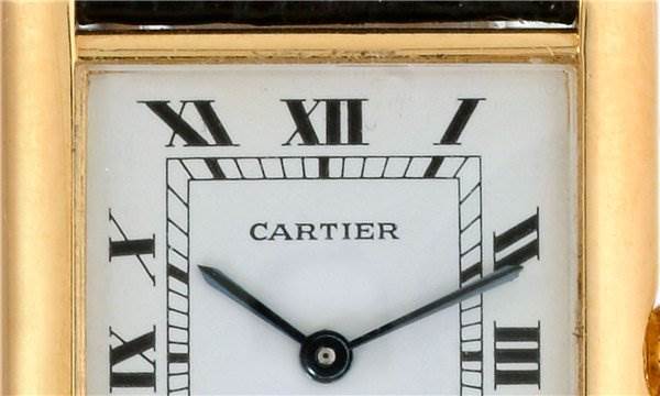 This image shows a close-up angle of the dial of the Cartier Tank Classic Men
s Steel and Gold (two tone) White Dial Men
s Steel and Gold (two tone) White Dial watch, highlighting the Roman numerals and hands.