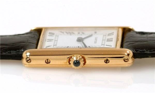 This image shows the side view of the Cartier Tank Classic Men
s Steel and Gold (two tone) White Dial Men
s Steel and Gold (two tone) White Dial watch with its crown and part of its leather strap visible.