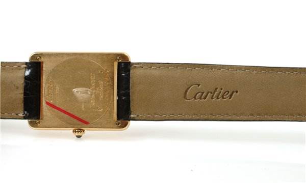 The image shows the back view of the Tank Classic model by Cartier, highlighting the case back and the leather strap.