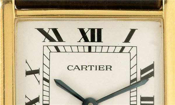 The image shows a close-up of the dial and part of the bezel of a Cartier Tank Classic Yellow Gold White Dial Yellow Gold White Dial watch.