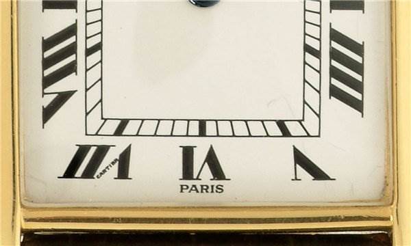 Close-up of the dial of the Tank Classic model by Cartier, focusing on Roman numerals and part of the case.