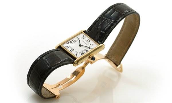 The Tank Classic model by Cartier is shown at a side angle, highlighting the rectangular face, black leather strap, and gold casing.
