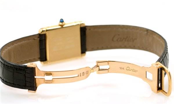 This image shows the back of a Cartier Tank Classic Yellow Gold White Dial Yellow Gold White Dial watch, highlighting the clasp and leather strap.
