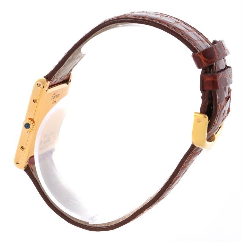 The image shows a side view of the Cartier Tank Classic Men
s Yellow Gold White Dial Men
s Yellow Gold White Dial watch, highlighting the case, crown, and brown leather strap.