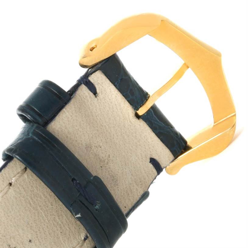 This is a close-up of the strap and buckle of a Cartier Tank Classic Men's Yellow Gold White Dial Men's Yellow Gold White Dial watch, showing its leather texture and gold-tone buckle.