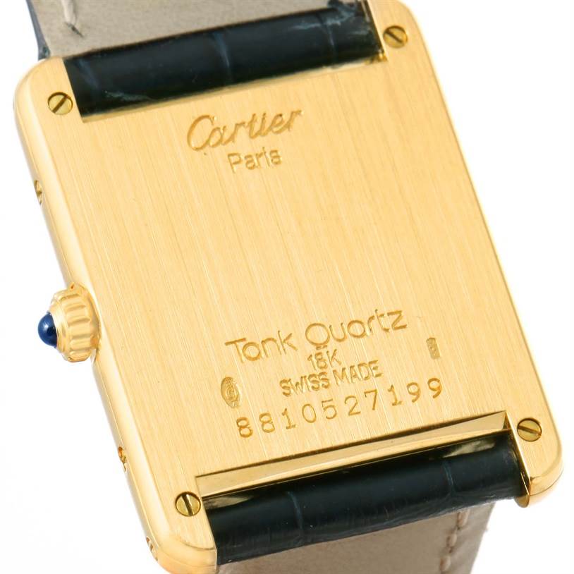 This image shows the case back of the Cartier Tank Classic Men's Yellow Gold White Dial Men's Yellow Gold White Dial watch, displaying its engravings and crown.