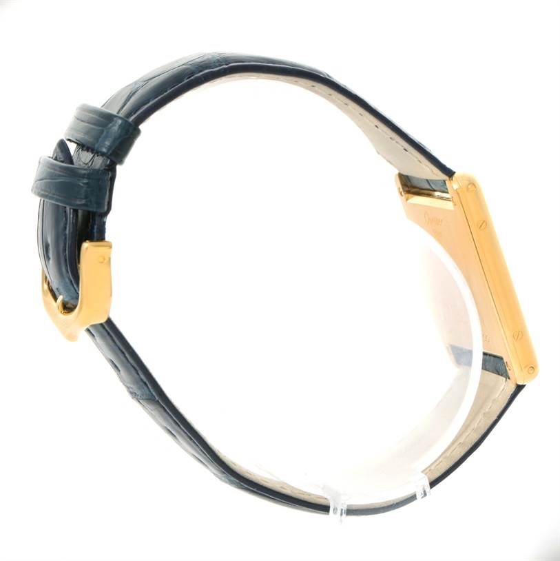 The image shows a side view of the Cartier Tank Classic Men's Yellow Gold White Dial Men's Yellow Gold White Dial watch, highlighting its gold case and black leather strap.