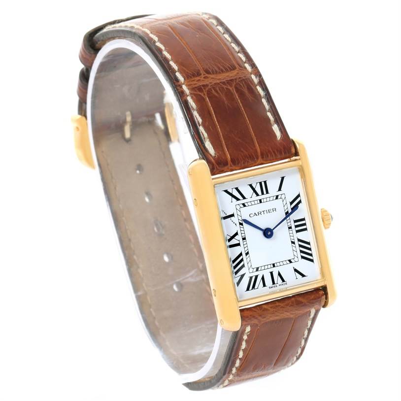 The image displays a Cartier Tank Classic Yellow Gold White Dial Yellow Gold White Dial watch at an angled view, highlighting its brown leather strap and rectangular face.