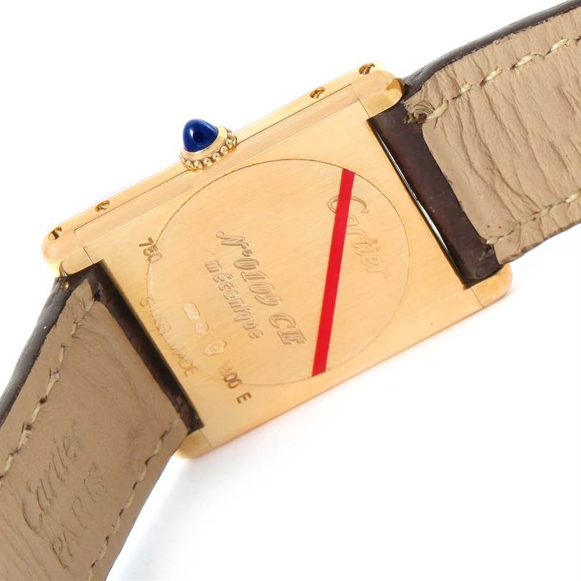 This image shows the back view of the Cartier Tank Classic Yellow Gold Silver Dial Yellow Gold Silver Dial model, highlighting the case back and part of the leather strap.