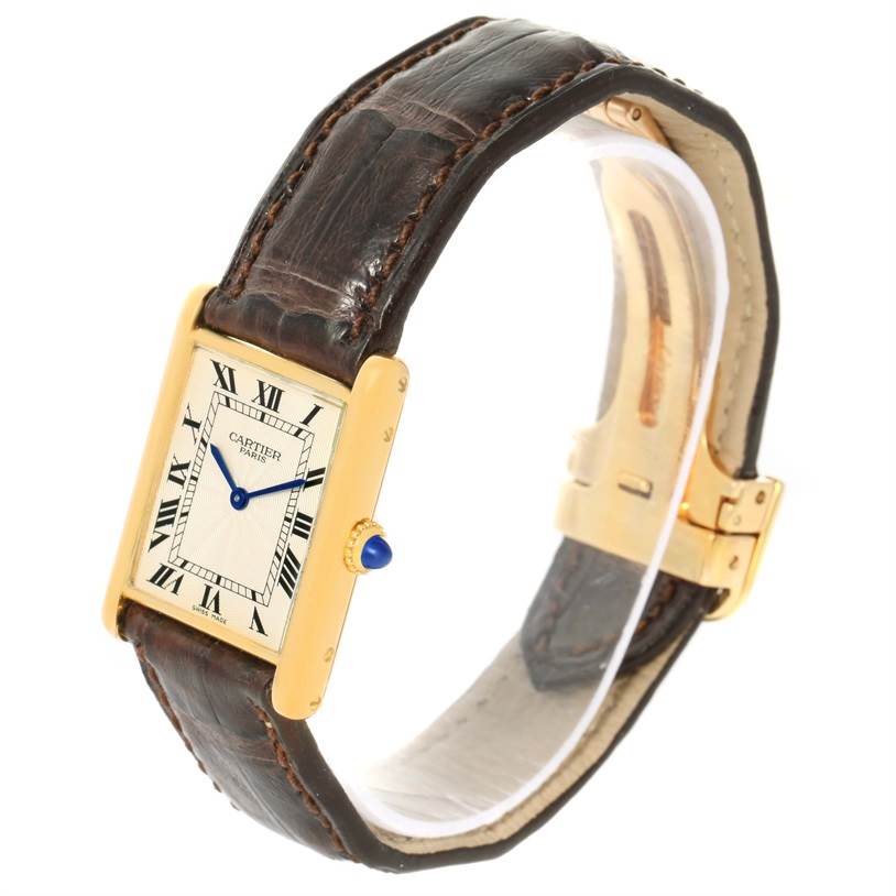 This image shows a Cartier Tank Classic Yellow Gold Silver Dial Yellow Gold Silver Dial watch at a three-quarter angle, highlighting the face, crown, and strap.