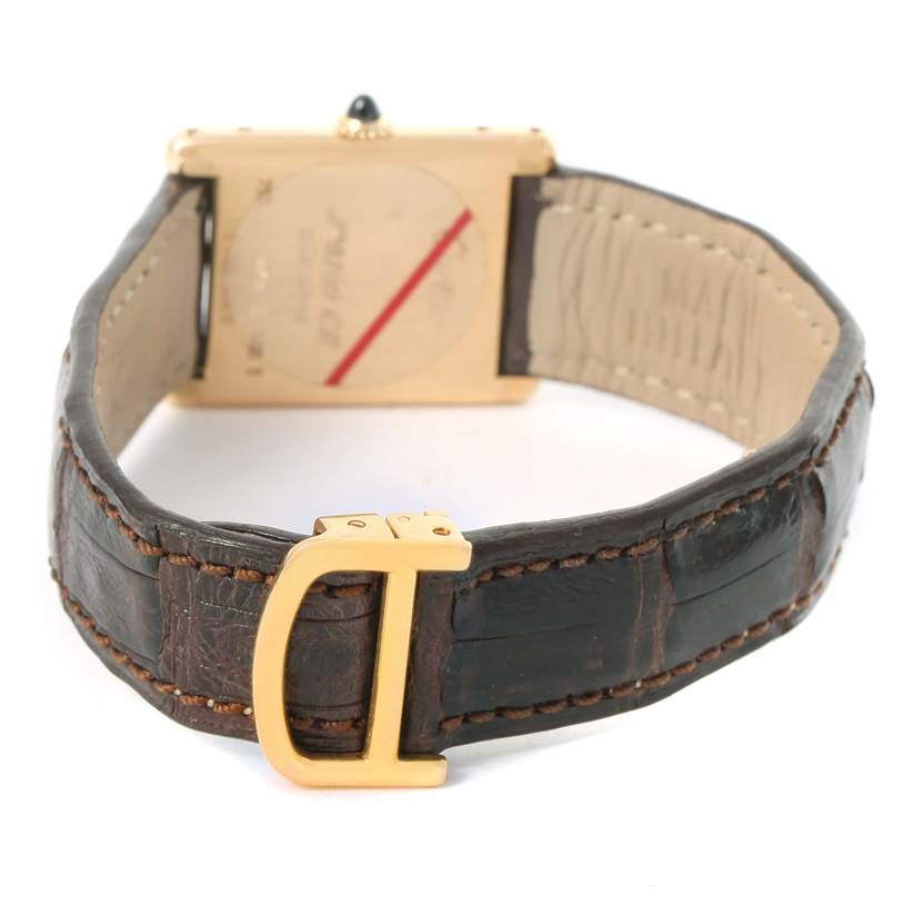 The image shows the back of the Cartier Tank Classic Yellow Gold Silver Dial Yellow Gold Silver Dial watch, focusing on the clasp and strap.