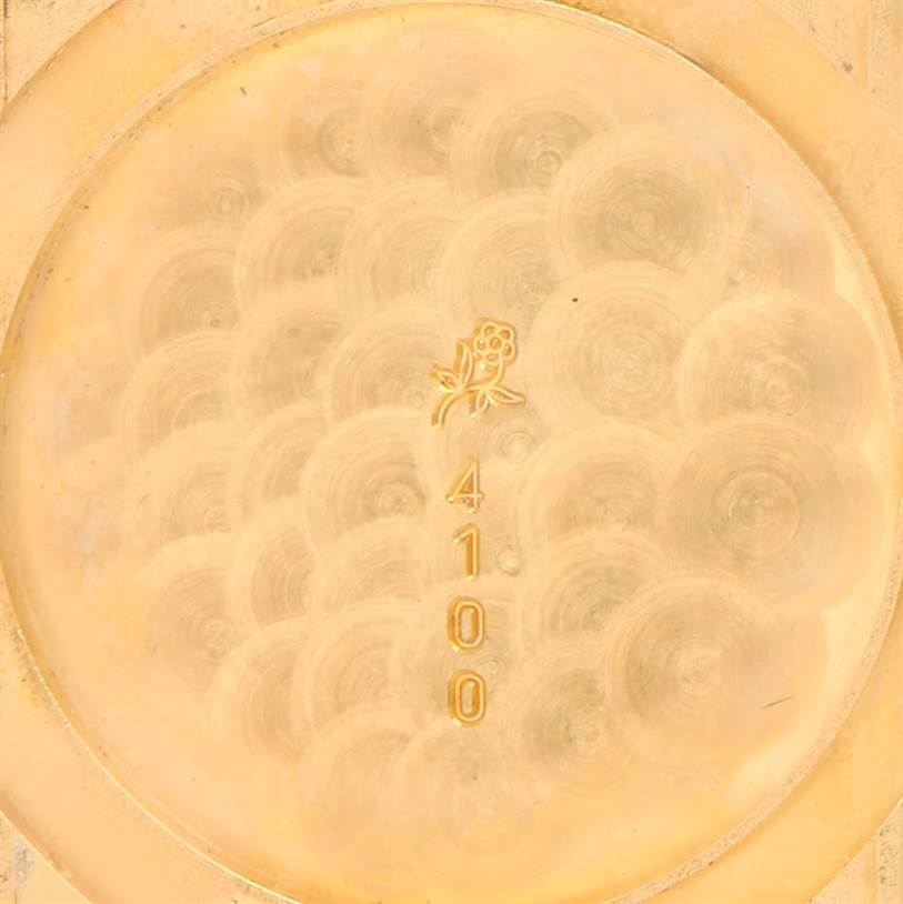 This image shows the inner case back of a Cartier Tank Classic Yellow Gold Silver Dial Yellow Gold Silver Dial watch, featuring engraved details.