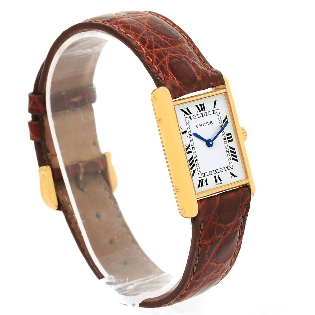 The image shows a Cartier Tank Classic Yellow Gold White Dial Yellow Gold White Dial watch at a slight angle, highlighting its rectangular face, gold case, and brown leather strap.