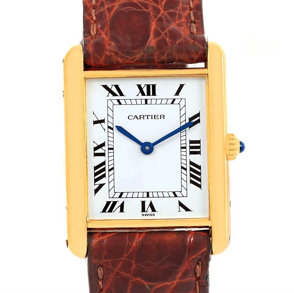 The image shows a front view of a Cartier Tank Classic Yellow Gold White Dial Yellow Gold White Dial watch, highlighting its rectangular face, Roman numeral markers, and leather strap.