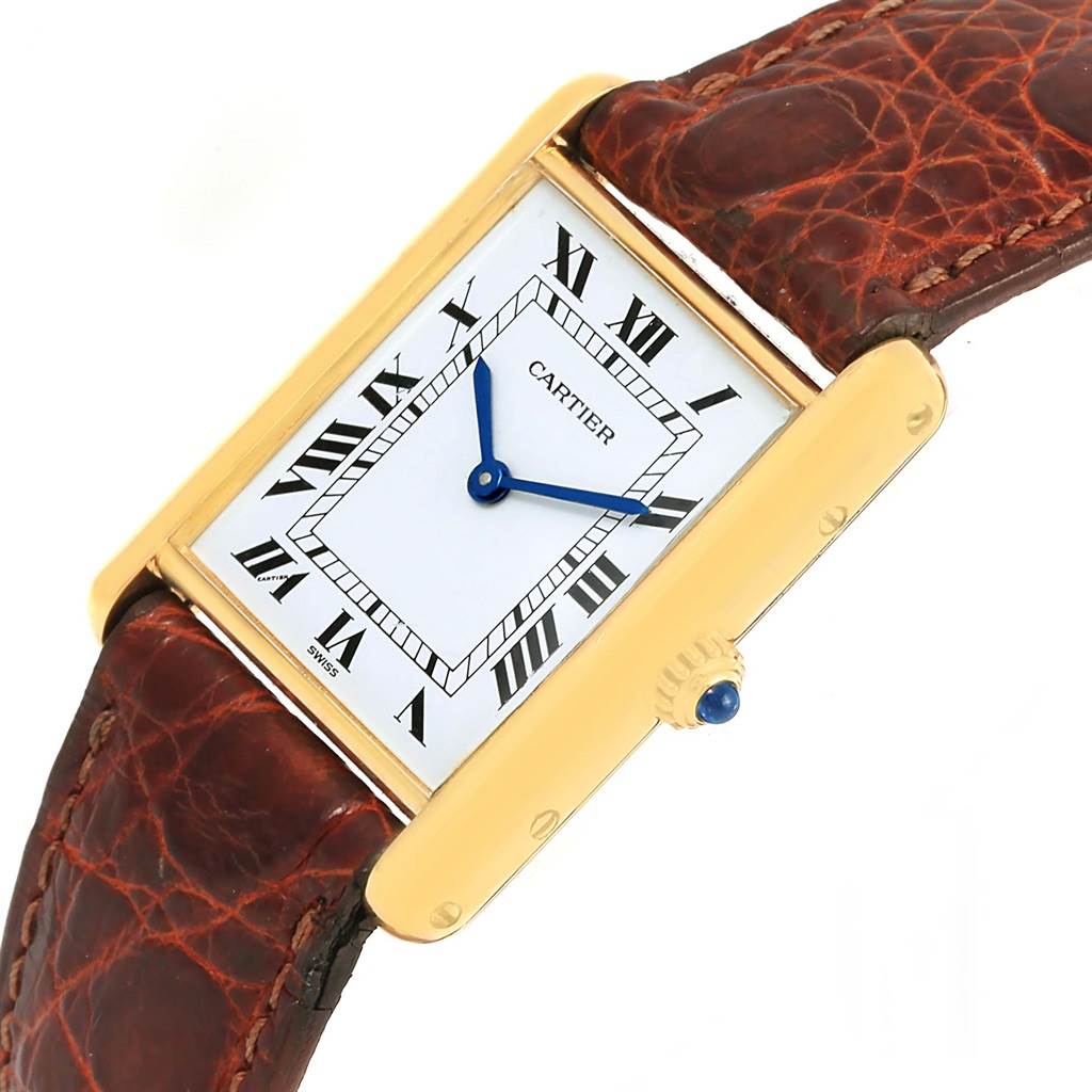 The image shows a Cartier Tank Classic Yellow Gold White Dial Yellow Gold White Dial watch at a slight angle, displaying the face, crown, and part of the leather strap.