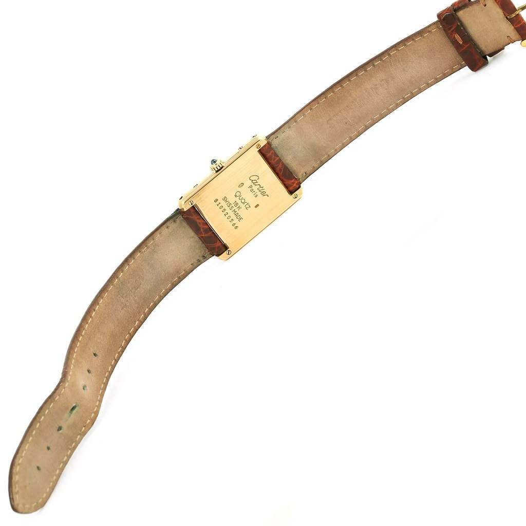 The image shows the back view of a Cartier Tank Classic Yellow Gold White Dial Yellow Gold White Dial watch, highlighting the case back and leather strap.