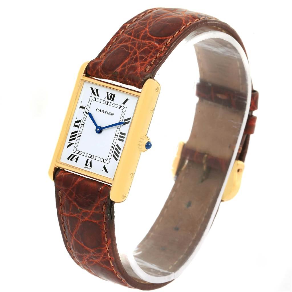 The image shows a Cartier Tank Classic Yellow Gold White Dial Yellow Gold White Dial watch from a front-side angle, displaying the face, case, crown, and strap.