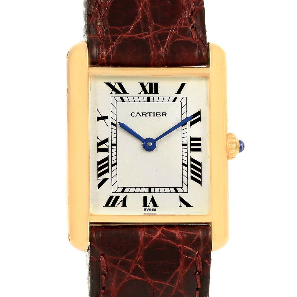 The image shows a front view of a Cartier Tank Classic 1140 Yellow Gold White Dial 1140 Yellow Gold White Dial watch, highlighting its rectangular face, Roman numerals, and leather strap.