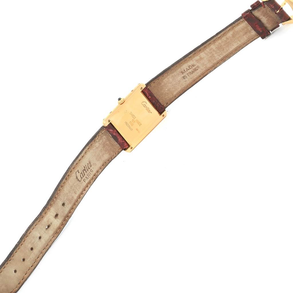 The image shows the back view of a Cartier Tank Classic 1140 Yellow Gold White Dial 1140 Yellow Gold White Dial watch, displaying its case back and leather strap.