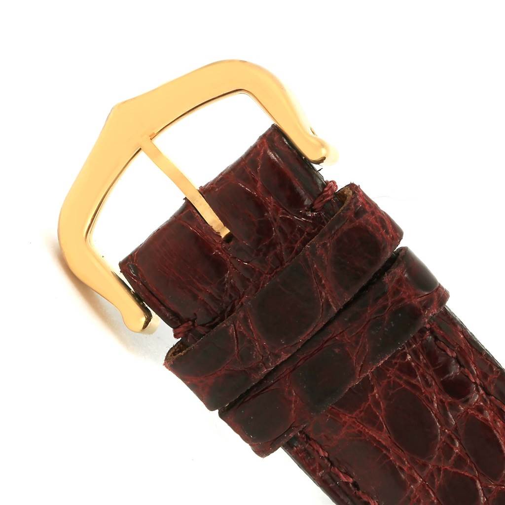 The image shows a close-up of the leather strap and gold buckle of the Cartier Tank Classic 1140 Yellow Gold White Dial 1140 Yellow Gold White Dial watch.