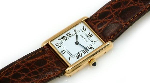 The image shows a top view of a Cartier Tank Classic Men's Yellow Gold White Dial Men's Yellow Gold White Dial watch with a brown leather strap and gold case.