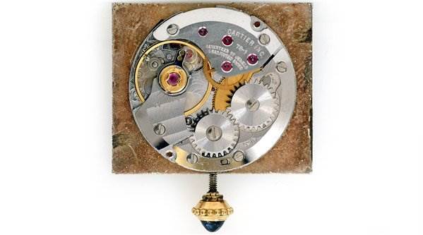 The image shows a close-up of the inner mechanical movement of a Cartier Tank Classic Men's Yellow Gold White Dial Men's Yellow Gold White Dial watch.