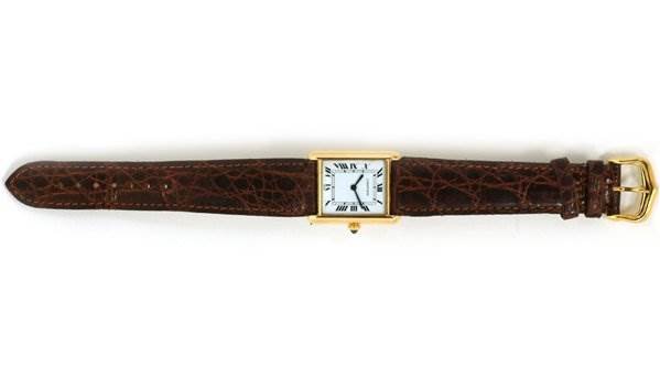 The image shows a top-down view of a Cartier Tank Classic Men's Yellow Gold White Dial Men's Yellow Gold White Dial watch with a gold rectangular case and brown leather strap.