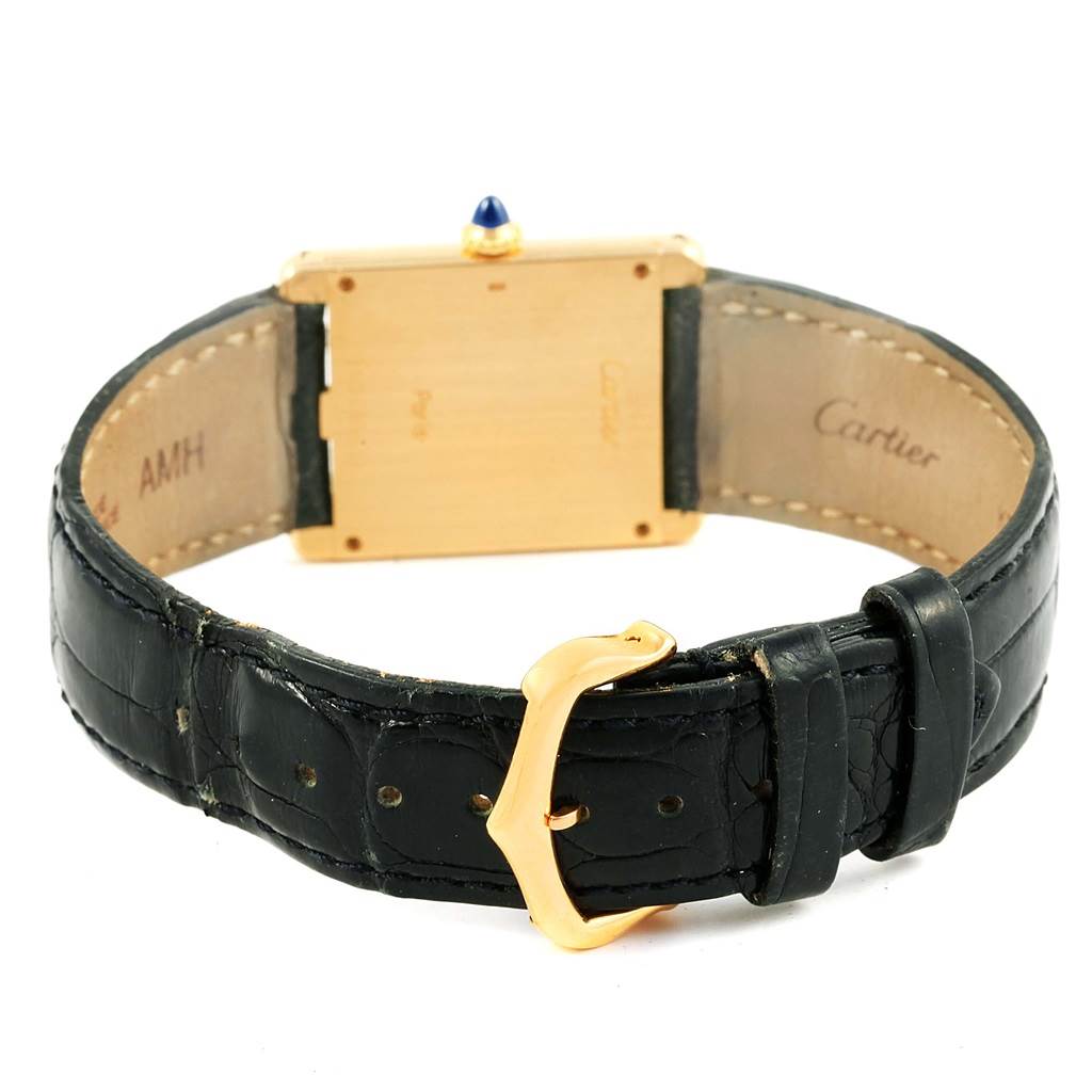 The image shows the back view of the Cartier Tank Classic Men's Yellow Gold White Dial Men's Yellow Gold White Dial model watch, highlighting the strap, buckle, and case back.