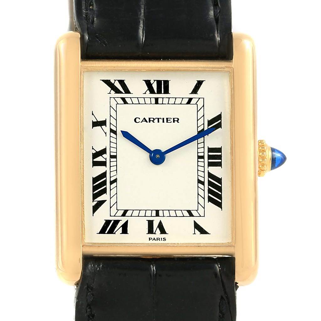 The image shows a front view of the Cartier Tank Classic Men's Yellow Gold White Dial Men's Yellow Gold White Dial watch, highlighting the dial, hands, case, and part of the strap.
