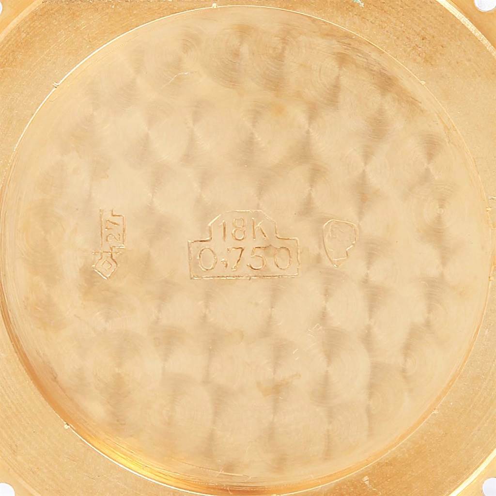 The image shows the inside of the case back of a Cartier Tank Classic Men's Yellow Gold White Dial Men's Yellow Gold White Dial watch, stamped with "18K 0.750."