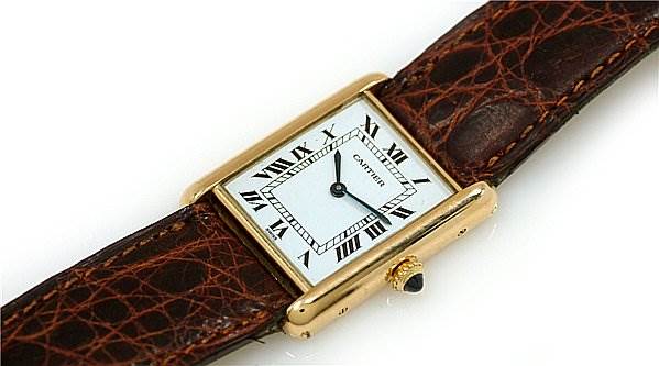 The image shows a close-up side angle of a Cartier Tank Classic Women's Yellow Gold White Dial Women's Yellow Gold White Dial model, displaying its rectangular face and brown leather strap.