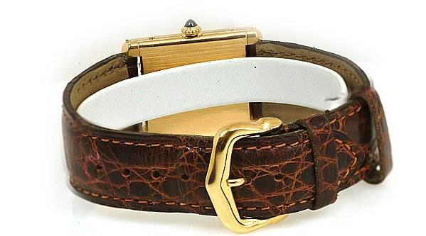 The image shows the back view of a Cartier Tank Classic Women's Yellow Gold White Dial Women's Yellow Gold White Dial watch, highlighting its leather strap and gold buckle.