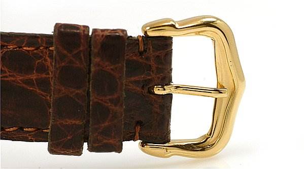 The image shows a close-up of the brown leather strap and gold buckle of a Cartier Tank Classic Women's Yellow Gold White Dial Women's Yellow Gold White Dial watch.