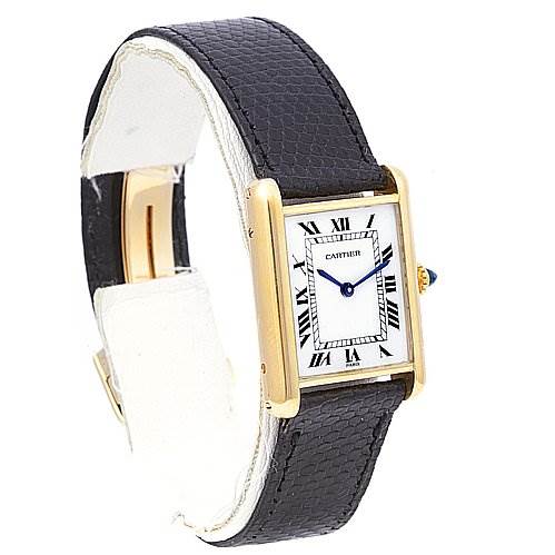 This image shows a Cartier Tank Classic Yellow Gold White Dial Yellow Gold White Dial watch at an angle displaying the face, bezel, crown, and black leather strap.