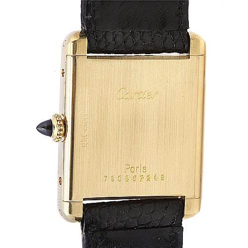 This image shows the back of a Cartier Tank Classic Yellow Gold White Dial Yellow Gold White Dial watch, specifically focusing on the case back and the strap connection.
