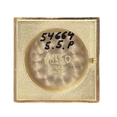 This image shows the back case of a Cartier Tank Classic Yellow Gold White Dial Yellow Gold White Dial watch, featuring engravings and markings.