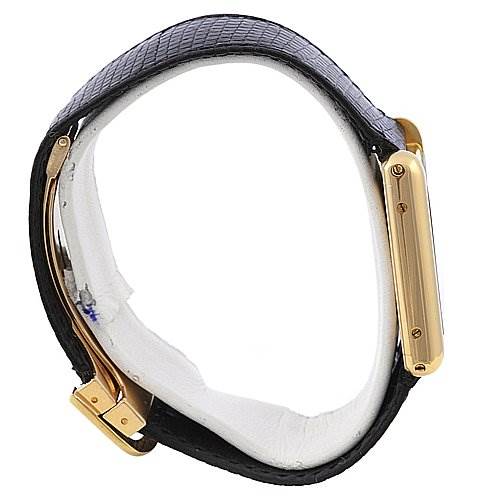 Side view of a Cartier Tank Classic Yellow Gold White Dial Yellow Gold White Dial watch showing the gold case, black leather strap, and clasp.