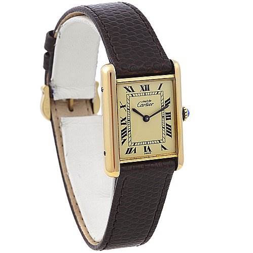 This image shows a Cartier Tank Classic Yellow Gold Beige Dial Yellow Gold Beige Dial watch from an angled front view, highlighting the watch face, strap, and buckle.