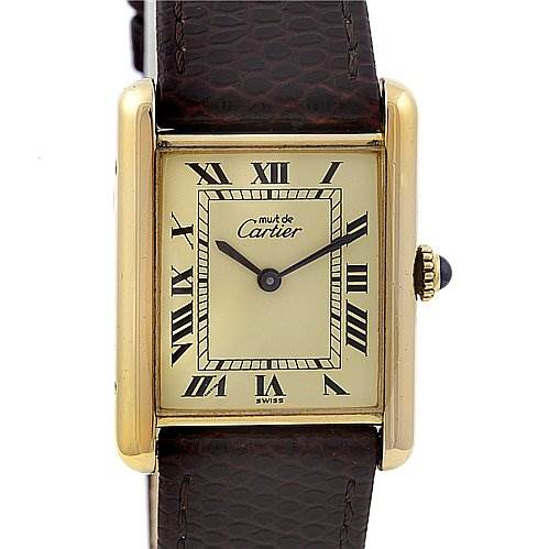 The image shows a front view of a Cartier Tank Classic Yellow Gold Beige Dial Yellow Gold Beige Dial watch, highlighting its face, Roman numeral dial, and strap.
