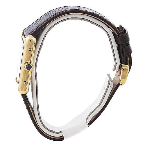 This image shows a side view of a Cartier Tank Classic Yellow Gold Beige Dial Yellow Gold Beige Dial watch, highlighting its case, crown, and leather strap.